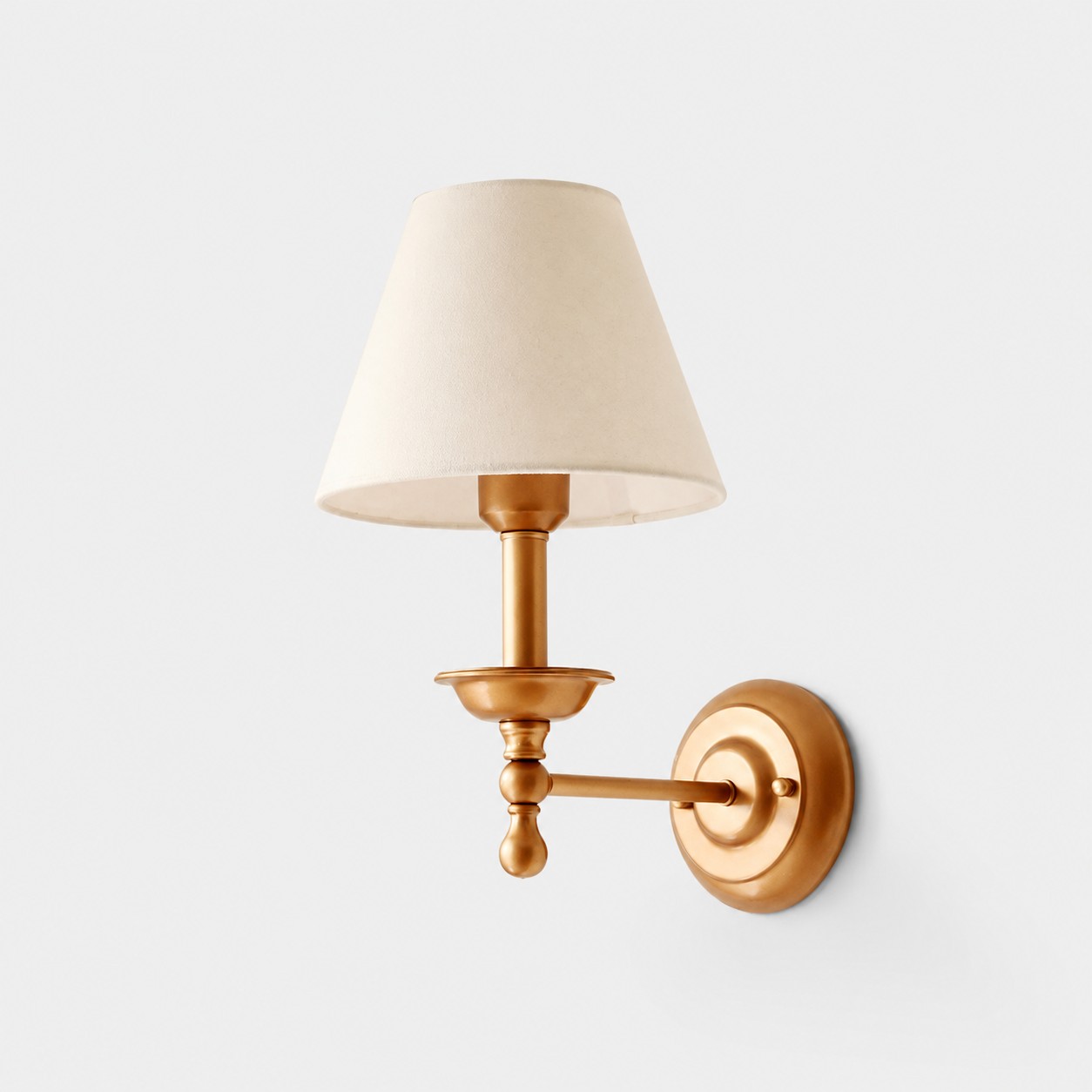 Conical shade wall sconce with brass lamp stand and ivory shade