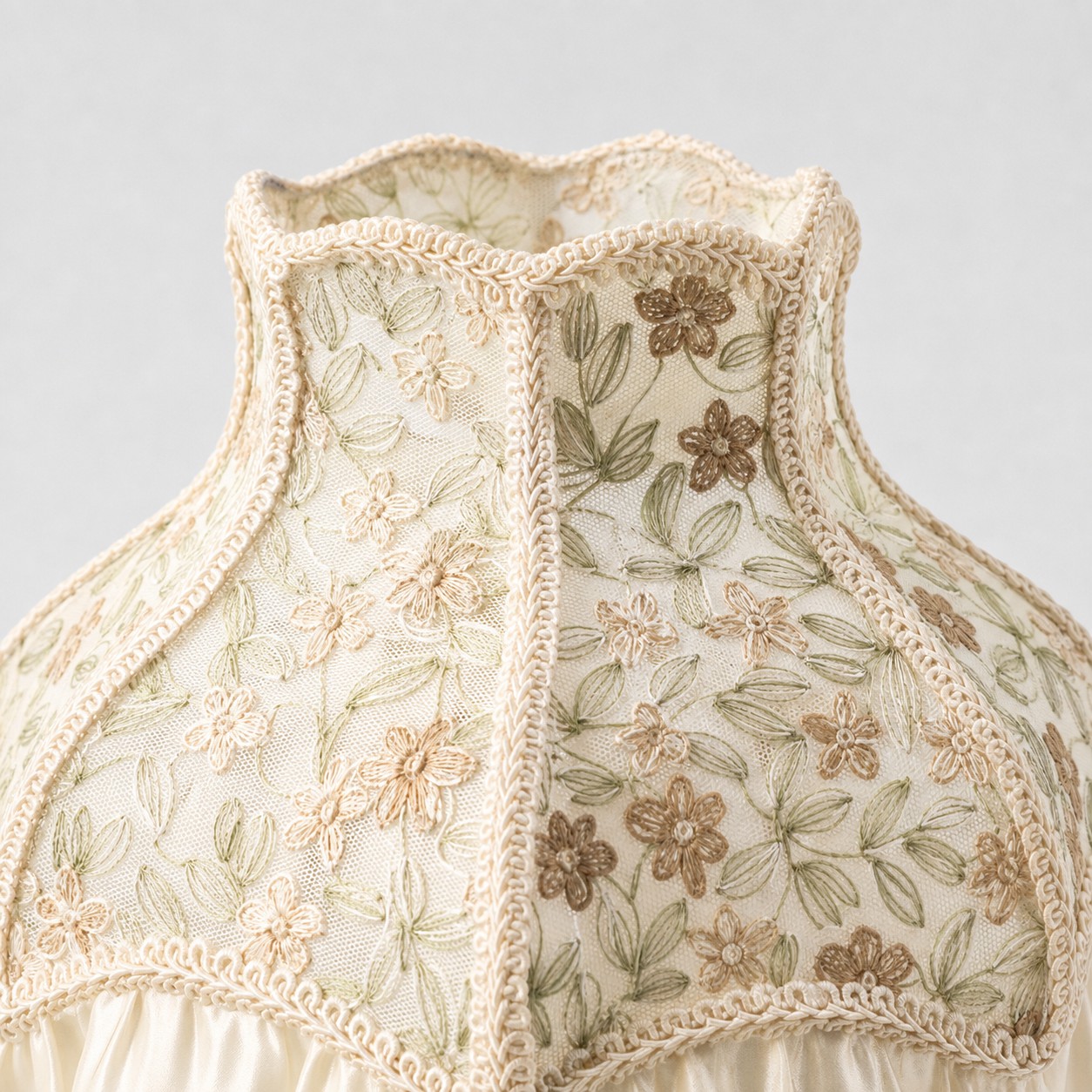 Floral embroidery and braided shade trim detail