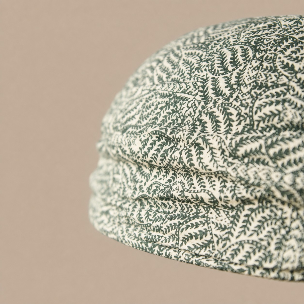 Close view of green botanical gathered fabric shade