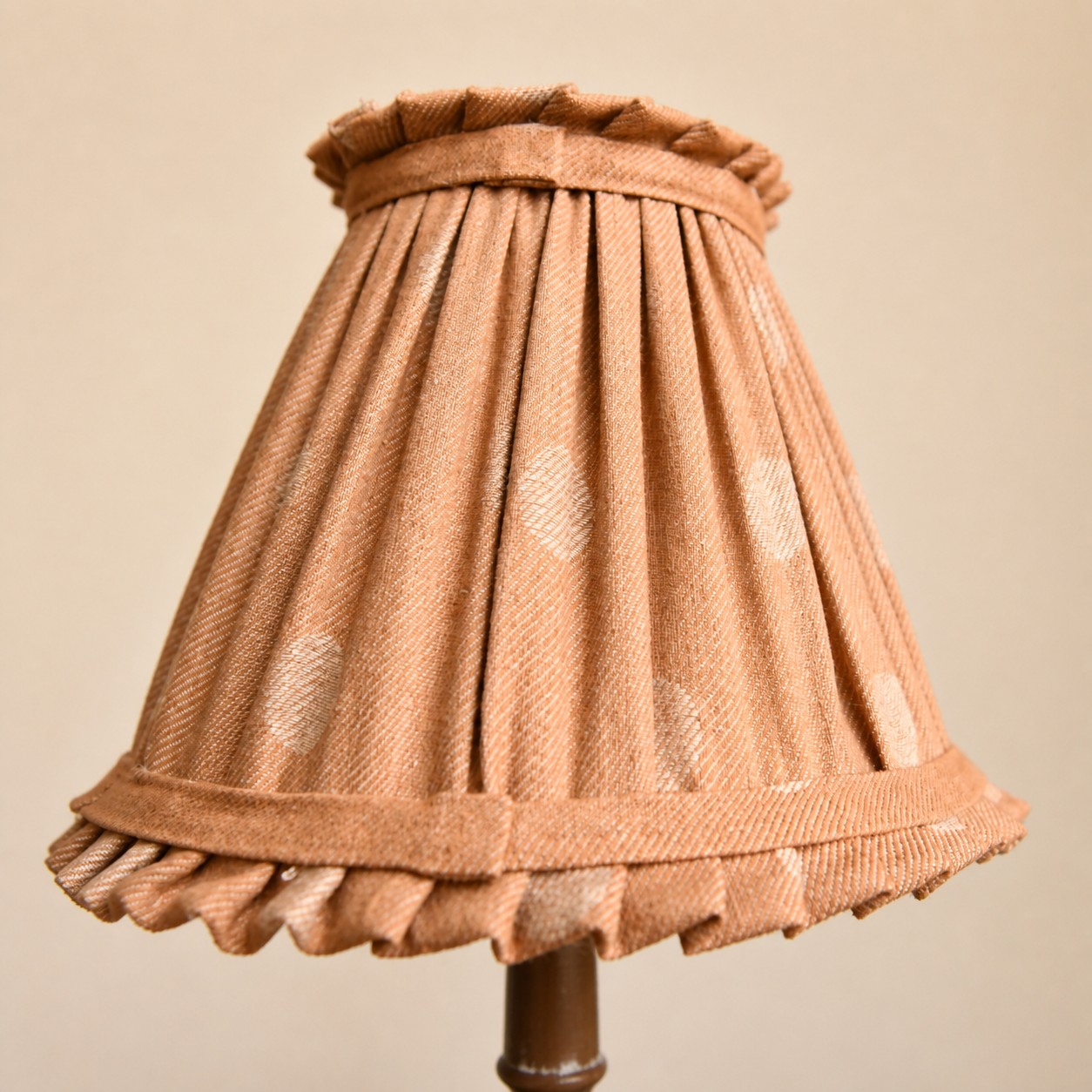 Pleated cloth lampshade close detail on French country table lamp