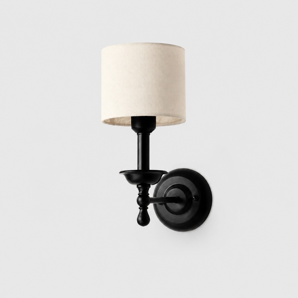 Conical shade wall sconce with wrought iron lamp stand in warm ivory shade