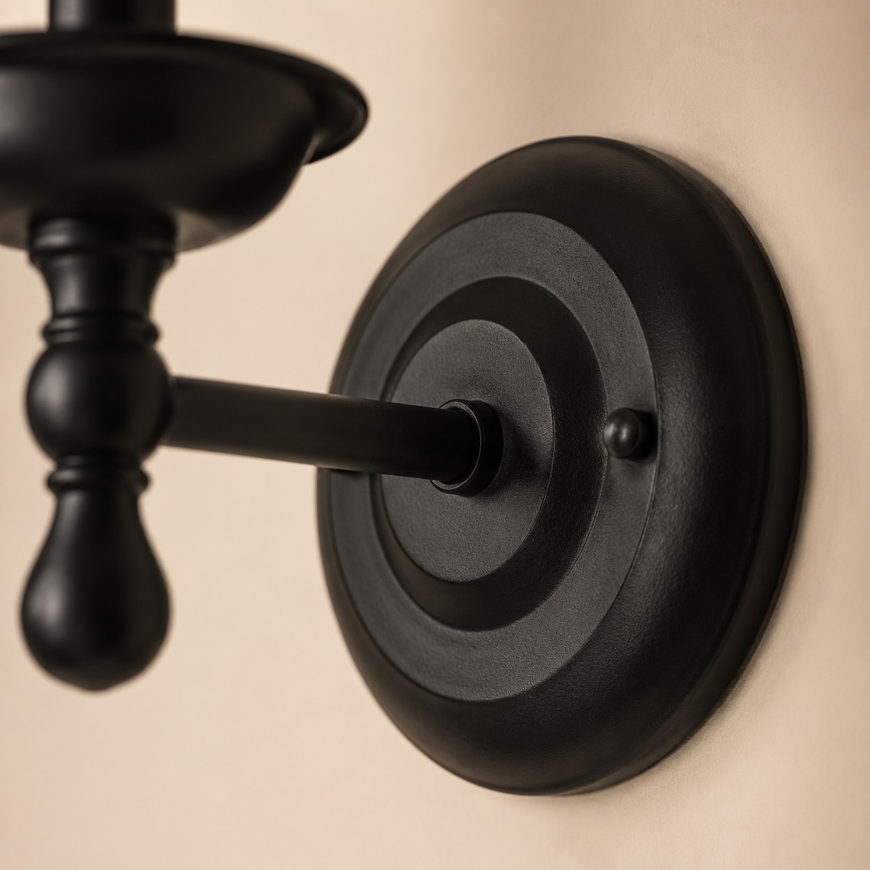 Close view of round wall plate and arm connection
