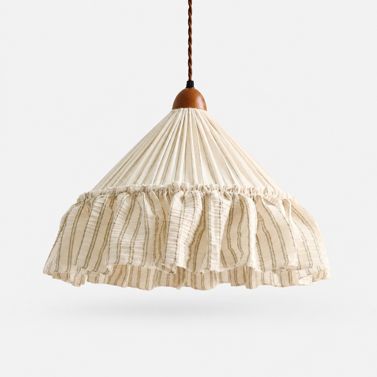 Fabric pendant above a stone dining table