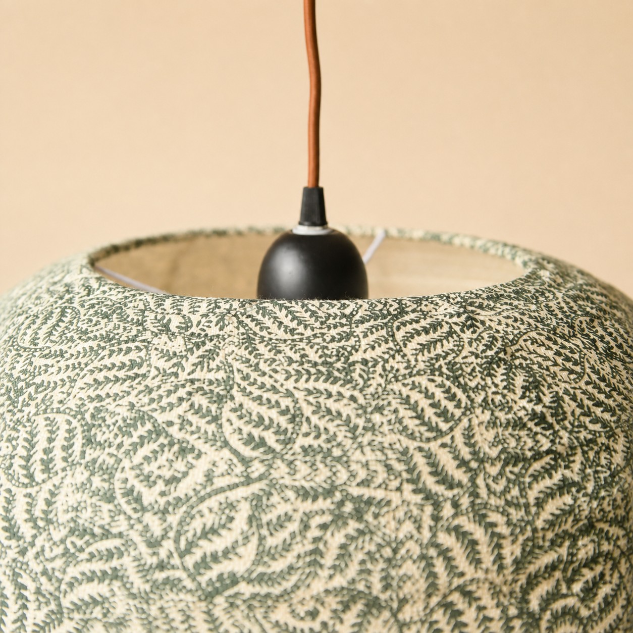 Close view of green botanical shade top and fitting