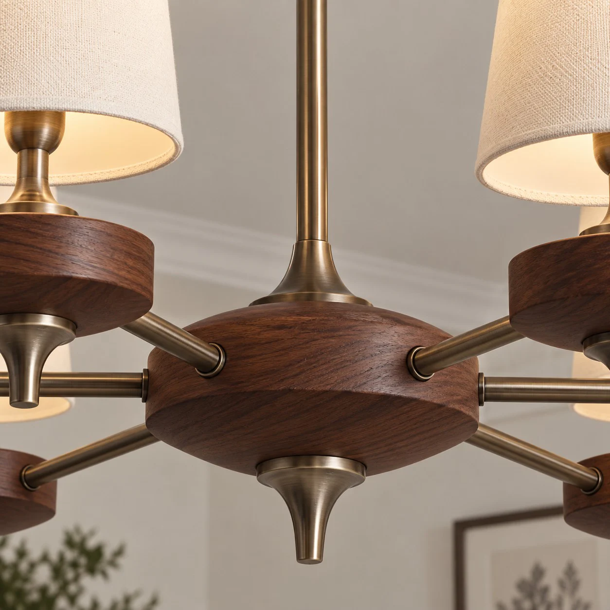 Close-up of the walnut-toned central hub and antique-bronze arms